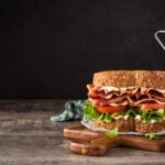 Blt,Sandwich,With,Bacon,lettuce,And,Tomato,On,Wooden,Table.,Copy
